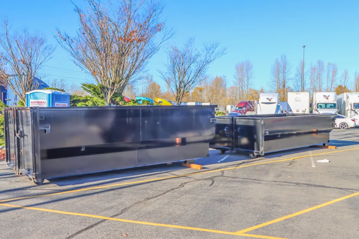 Professional dumpster rental service with roll-off container on residential driveway in Red Oak
